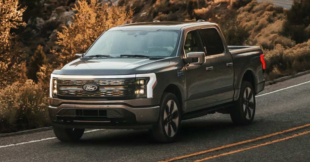 2025 Ford F-150 driving on a country road in the fall