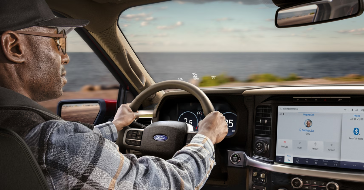Ford interior with a driver looking through his windshield and dashboard