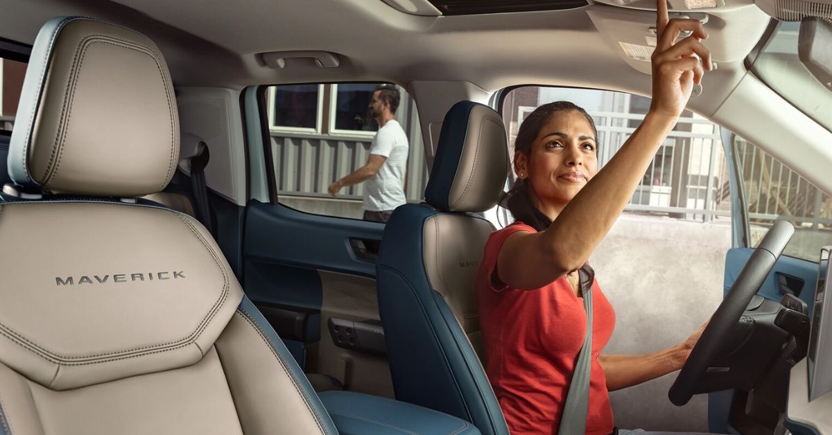 2025 Ford Maverick interior with the driver pressing a button on the roof