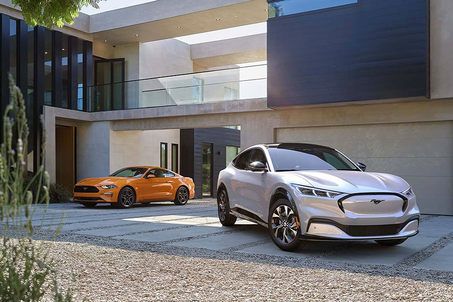 two Ford Mach-ev parked outside house