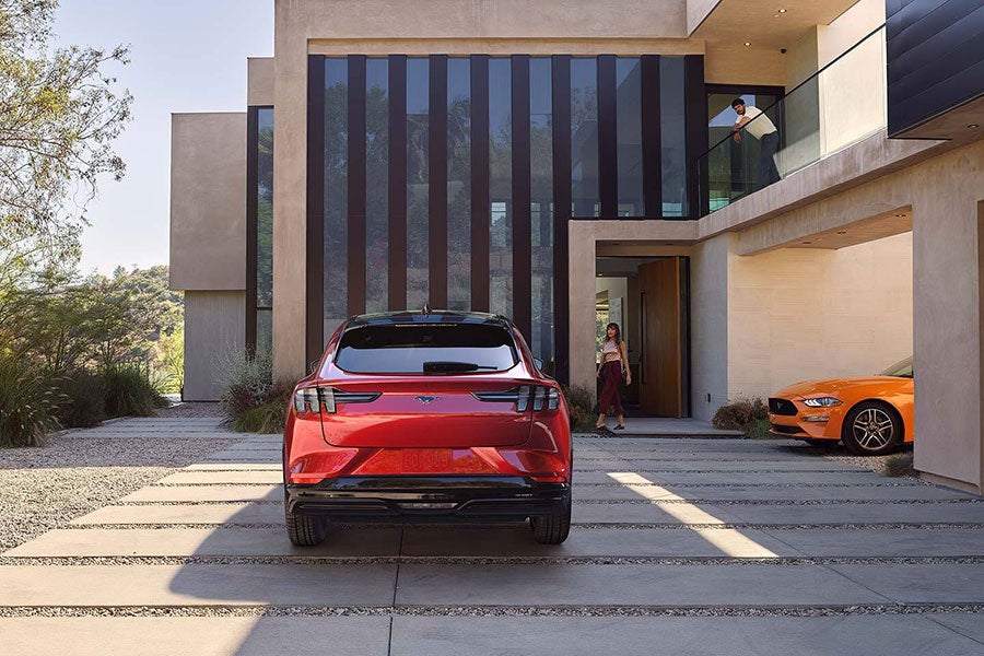 back view of Ford Mach-ev parked outside house
