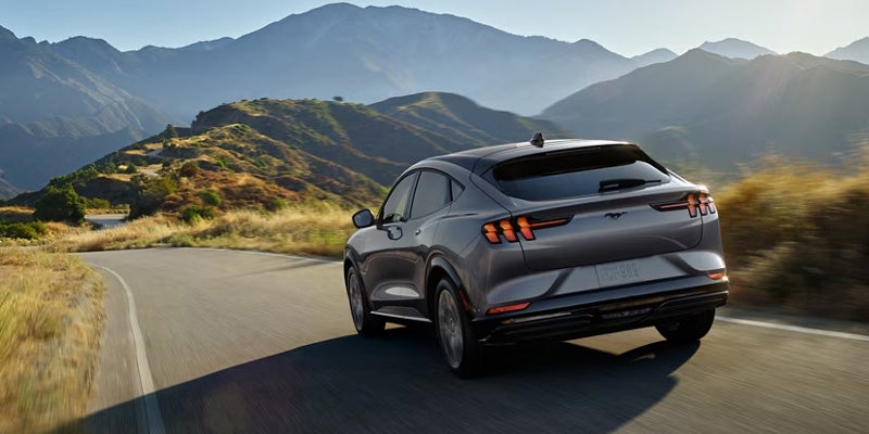 back view of Ford Mustang Mach-E running on road