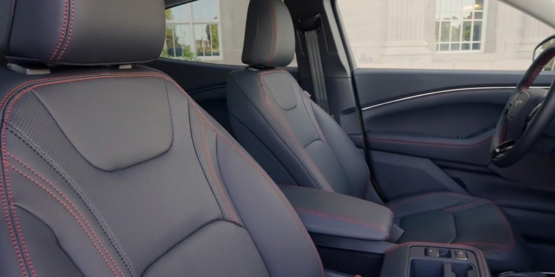 Close-up view of front car seats upholstered in dark leather