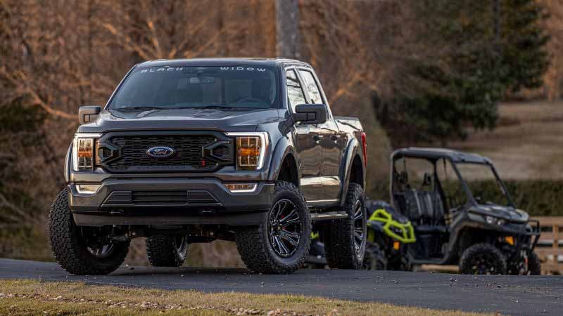 Black Widow Lifted Truck parked on driveway
